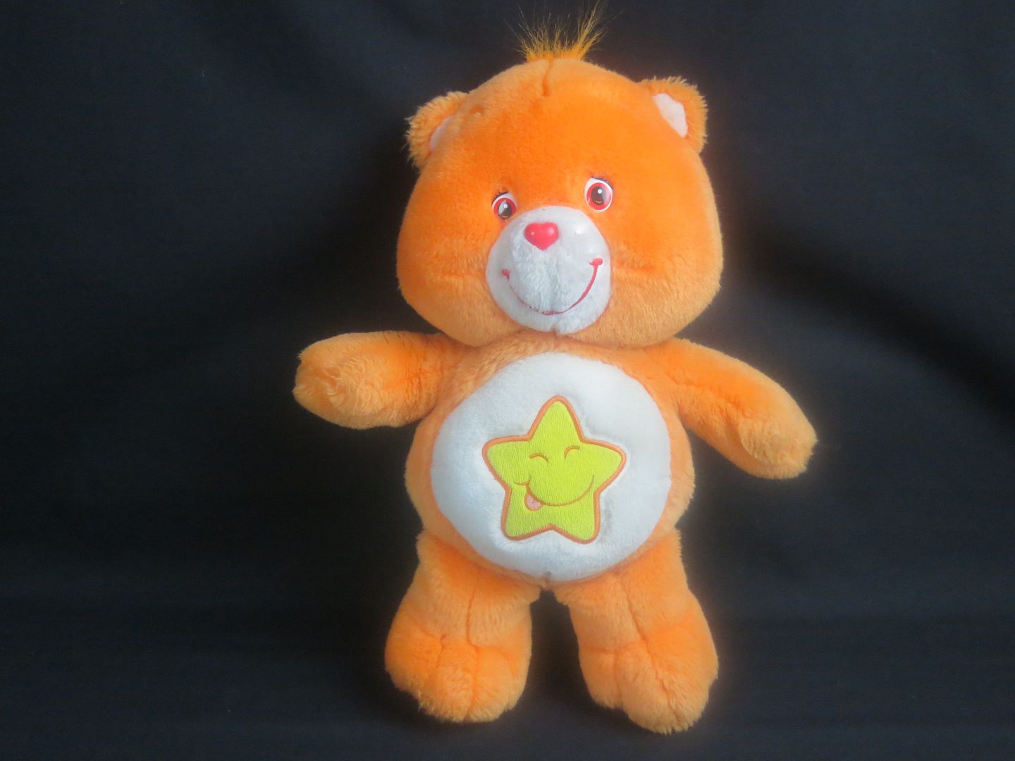 orange care bear with a star