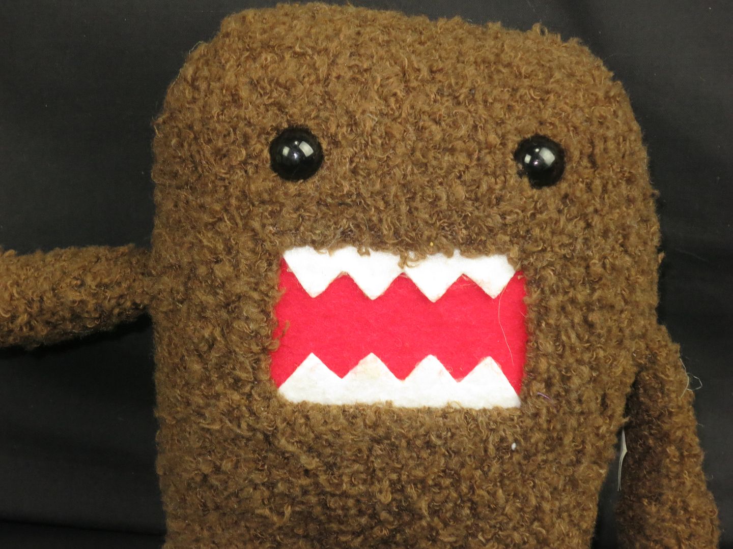 brown stuffed animal with teeth